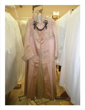 This decorative pink satin coat was worn by a truly fashionable lady around 1890-1900.