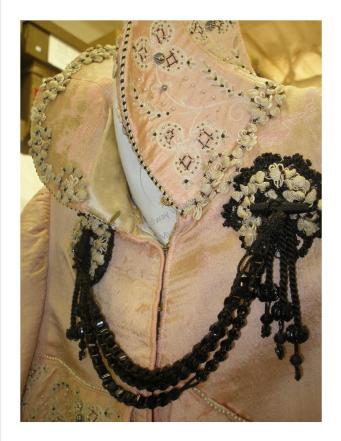Note the exquisite bead and embroidery detail under the collar.